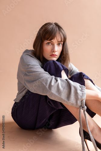 Pensive woman sitting thoughtfully.