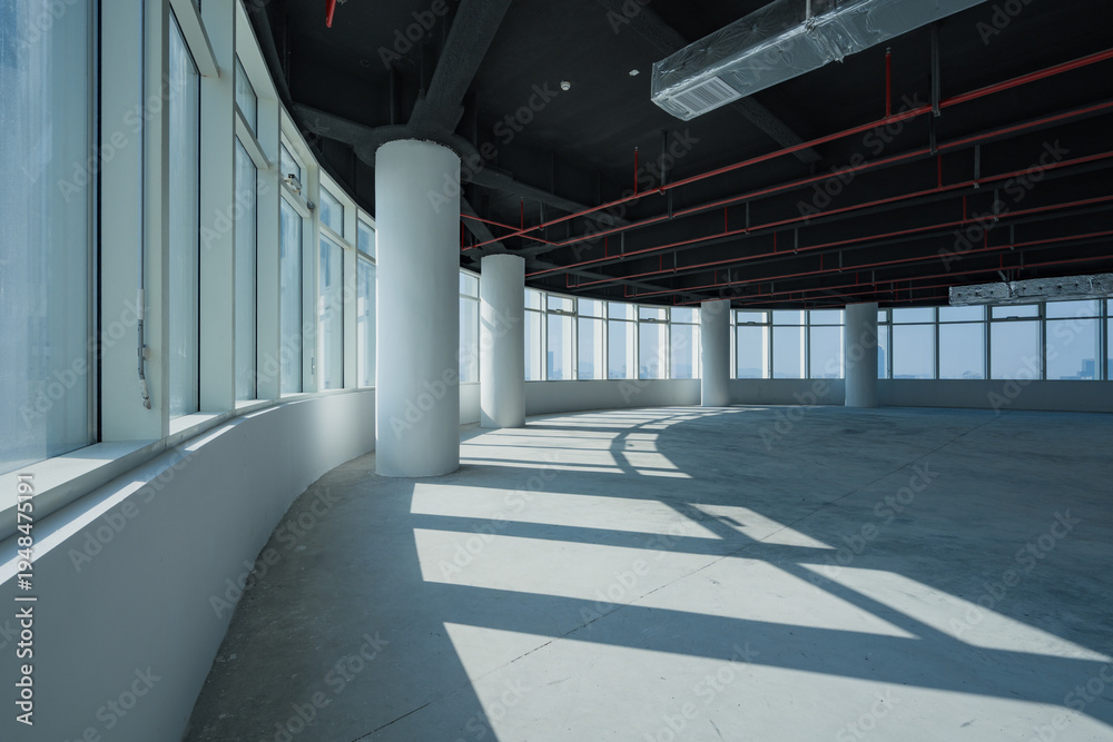 Fototapeta premium Modern spacious office interior with curved floor-to-ceiling windows and exposed structural elements