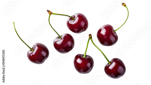 Foto Six vibrant red ripe sweet cherries with green stems, naturally scattered and is