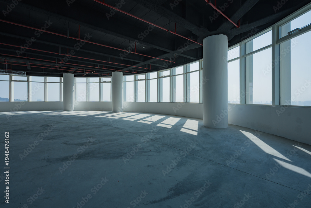 Fototapeta premium Spacious empty office interior with abundant natural light and modern architectural elements