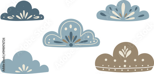 Five decorative metal crown shaped cookie cutters in various shades of blue and gold on a white background