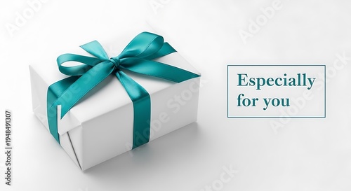 Elegant white gift box with a teal ribbon and message