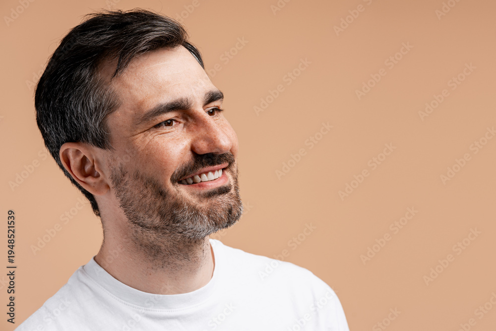 Fototapeta premium Happy smiling middle aged man looking away with positive expression