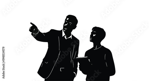 Two business professionals discussing and pointing at something in a corporate setting with teamwork and collaboration concept