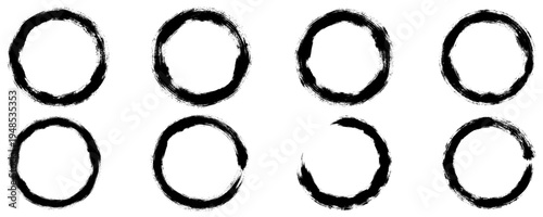 A set of circular graphic elements made in the style of rough brush strokes, prints, and splashes. Includes both solid textured circles and open rings in the enso aesthetic. Vector illustration.