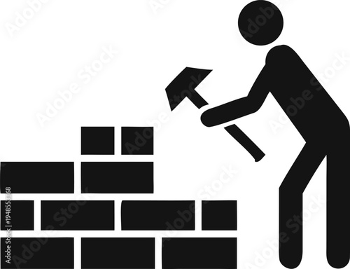 Worker diligently building a sturdy brick wall with a hammer for solid construction