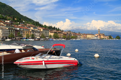 Red and white speedboat on Lake Garda with alpine backdrop, Salo