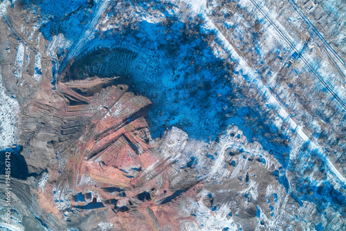 Slag Heap Spoil Tip in Mining Area with Red Industrial Waste and Snow Abstract Environmental Landscape High Angle Aerial Drone View