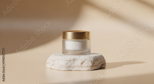 Frosted glass cosmetic cream jar with gold lid on marble platform