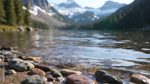 Serene Mountain Lake Shore with Rocky Beach and SnowCapped Peaks.