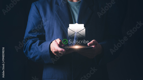 Concept of digital marketing and online registration, electronic mail communication, and business connectivity, A professional businessman using a smartphone for email newsletter subscription.