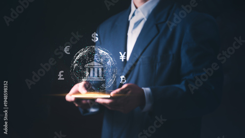 Concept of international finance, fintech investment, and global money transfer, a businessman holding a smartphone with digital global banking and currency symbols.