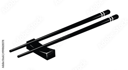 A pair of black chopsticks and a matching rest on a white background