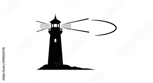 Silhouette of a lighthouse emitting a beam of light across the sea at night