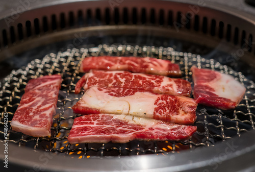 Raw beef slice on grille for barbecue or Japanese style yakiniku