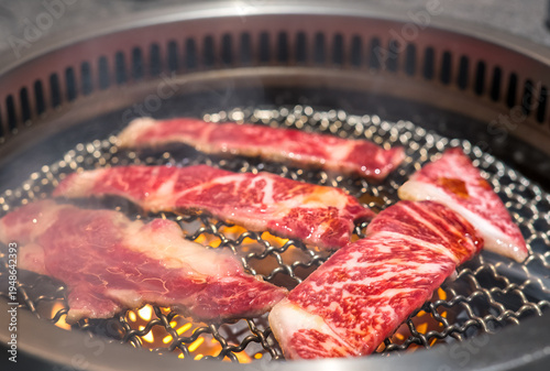Raw beef slice on grille for barbecue or Japanese style yakiniku