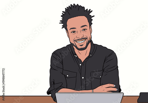 Smiling man sits at a desk with a laptop, engaging in work or leisure in a simple indoor setting