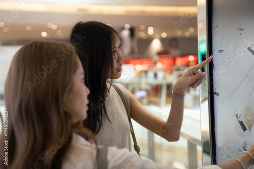 Εκτύπωση καμβά Women using interactive digital kiosk at shopping mall