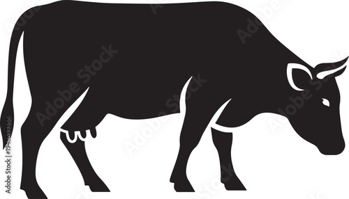 Black silhouette of a cow standing alone in a field