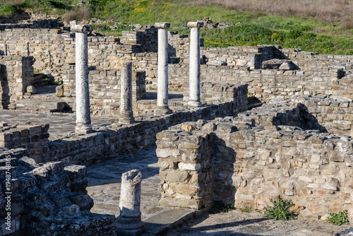 Bild auf Leinwand white marble columns stand among the excavated stone walls of an ancient roman c