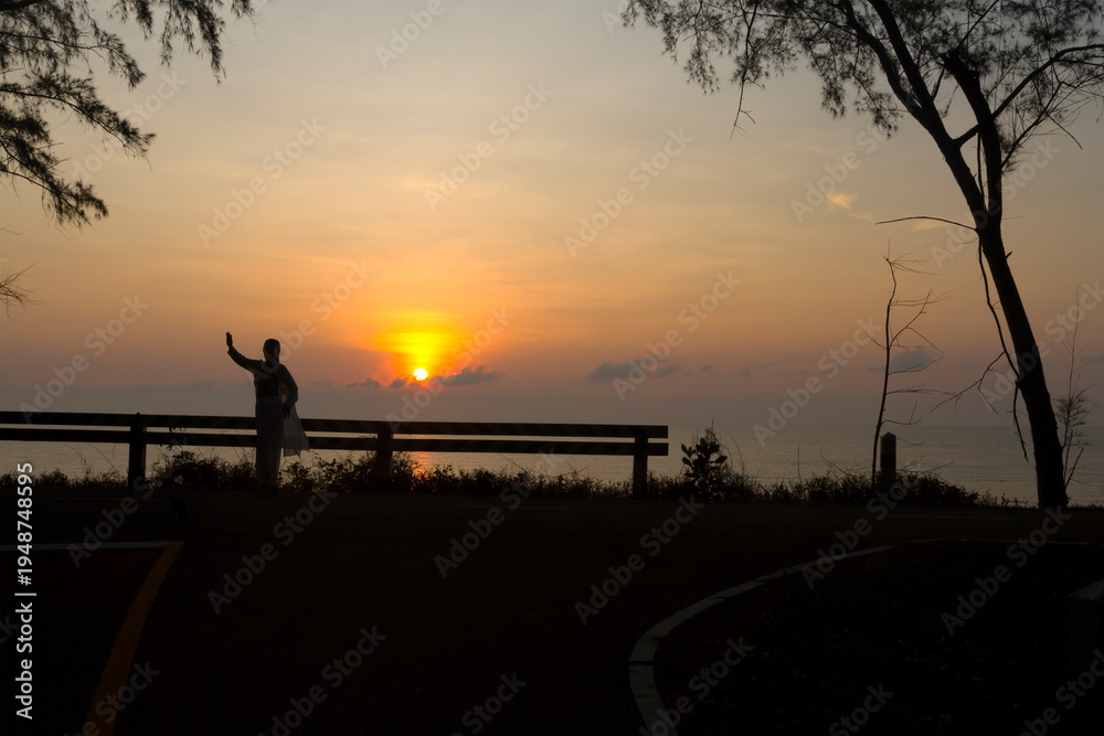 Fototapeta premium Sunrise and traveler with silhouette