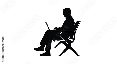 Silhouette of a professional man working diligently on a portable computer while seated in a modern airport chair