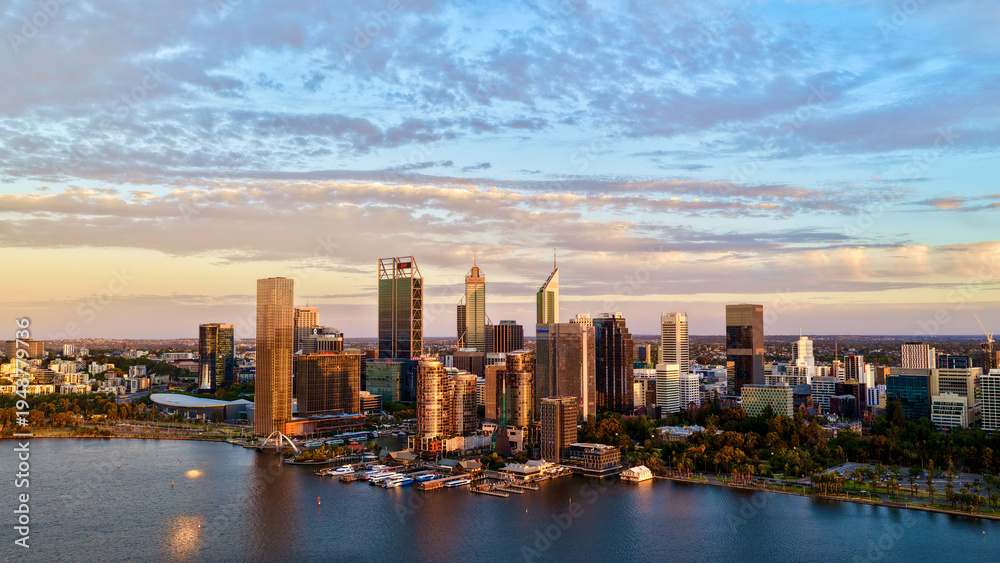 Obraz premium Perth City at Sunrise, Western Australia – 4K Aerial Drone View of Skyline, Swan River, Central Business District, CBD, Modern Skyscrapers, Waterfront Marina, Swan River and Golden Morning Light