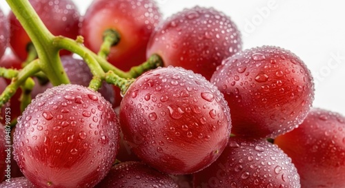Close-up of fresh red grapes covered in glistening water droplets.