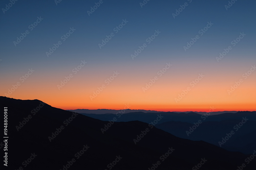 Obraz premium Minimalist sunrise over mountain silhouettes with a smooth gradient sky. Clean modern nature background with large copy space for design, presentations, and website banners.