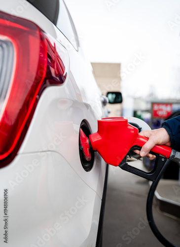 Wallpaper Mural Close up of hand on fuel nozzle filling the tank of car with gas. Torontodigital.ca