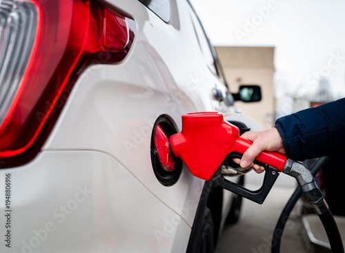 Wallpaper Mural Close up of hand on fuel nozzle filling the tank of car with gas. Torontodigital.ca