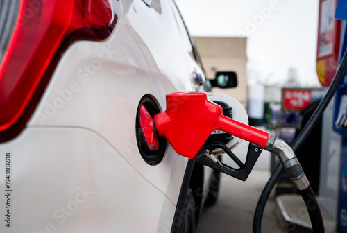 Canvas Print Close up of fuel nozzle of gas pump filling the tank of a vehicle