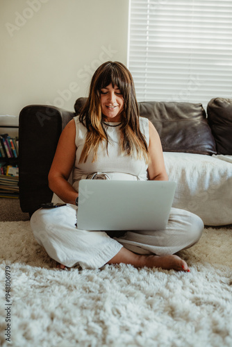 Wallpaper Mural Woman working remotely from home sitting on floor Torontodigital.ca