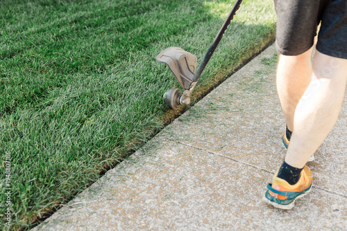 Man using electric edger to care for lawn