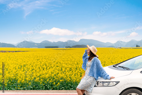 Canvas Print Happy young woman enjoying the canola fields while traveling to Luoping County i