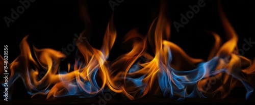 The Flames Dance in Blue and Orange Over a Smooth Reflective Black Surface