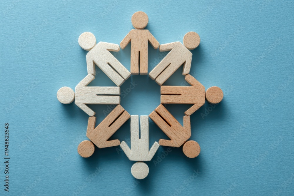 Obraz premium Unity in a Circular Embrace: A harmonious arrangement of diverse wooden figures forms a circle, symbolizing unity, support, and collaboration on a soft blue background.