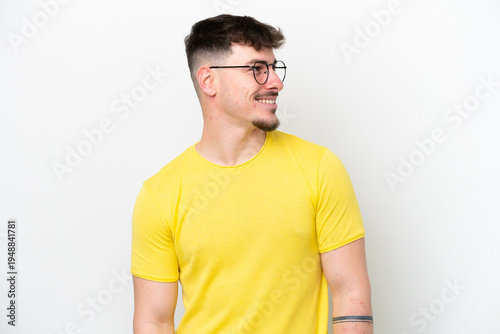 Young caucasian handsome man isolated on white background looking side