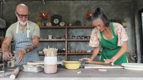 A happy couple makes ceramic plates in a workshop