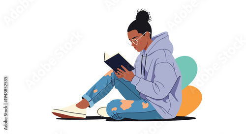 Young woman wearing glasses and a hoodie sitting on the floor and focused on reading a book with abstract shapes behind her.