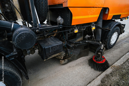Vehicle sweeping streets, cleaning up sidewalk