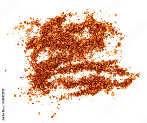 Pile of crushed red chili flakes and seeds scattered. Top view of spicy condiment powder used for cooking and seasoning. Isolated culinary ingredient for food design.