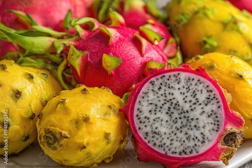 Close-up of vibrant dragon fruits; red, yellow hues, one sliced open, textured
