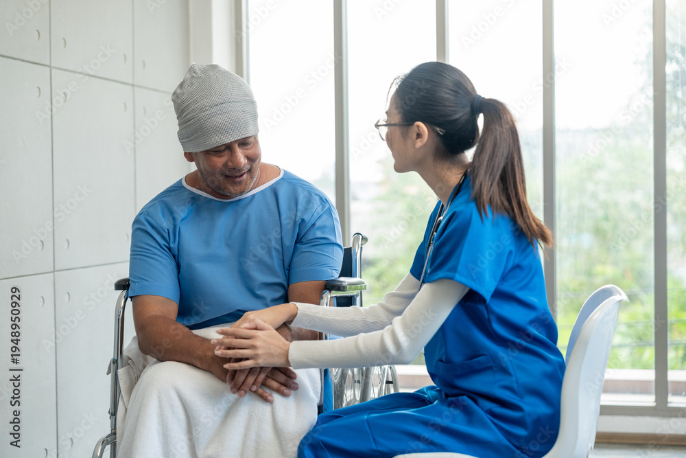 Obraz premium A male cancer patient in a wheelchair receives IV therapy while a female doctor offers care encouragement and updates on his test results providing support and discussing health progress
