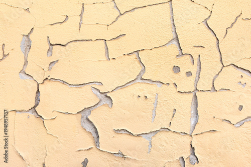 Cracked plaster on the wall as a background, texture, pattern.