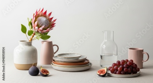 Elegant Tableware and Fresh Fruit Arrangement with Protea Flower