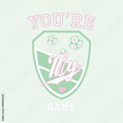 Cute pastel soccer crest emblem graphic design featuring pink hearts, footballs, and You're my game typography. Perfect for girls t-shirt print, apparel, and fashion.