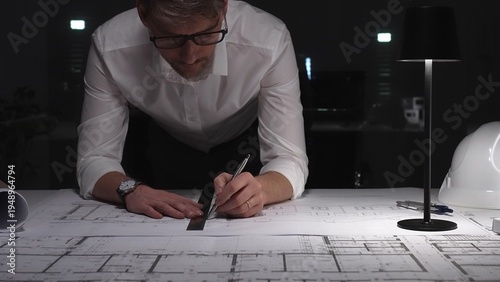Принти на полотні Architect working on blueprints late at night, focusing on construction plans and project engineering design