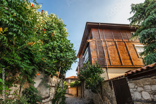 Traditional wooden house and narrow street in historic old town Nessebar Bulgaria