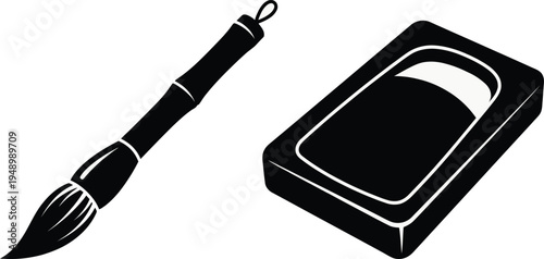Classic East Asian calligraphy brush and traditional carved inkstone showing essential artistic tools used for ancient oriental painting and beautiful handwriting.